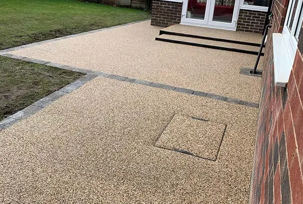 Resin bound patio beside a garden