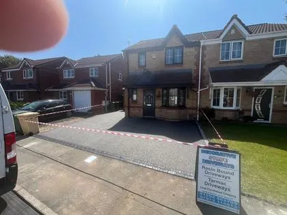 Newly installed grey resin bound driveway at a residential property
