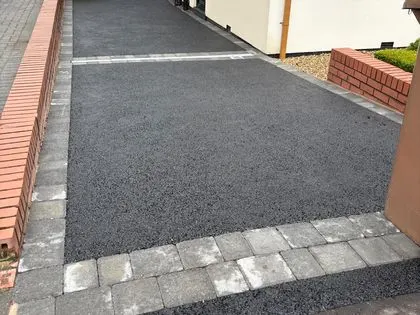New black tarmac side driveway with grey block edging